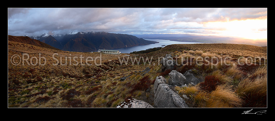 Image of Sunrise on Luxmore Hut, first hut on Kepler Track Great Walk. Lake Te Anau and Murchison Mountains beyond. Dawn, Fiordland National Park, Southland District, Southland Region, New Zealand (NZ) stock photo image