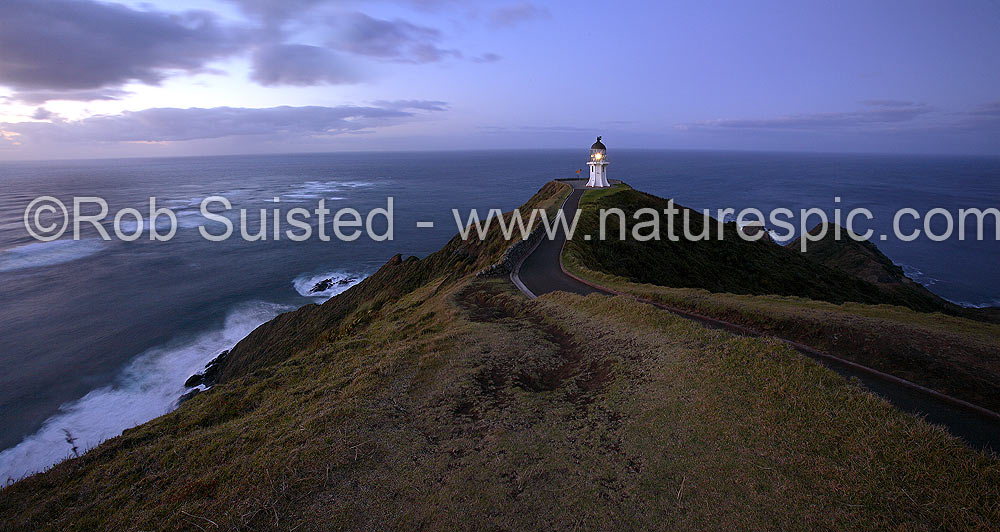 Image of Cape Reinga lighthouse (Te Rerengawairua) with last light of day, dusk. Columbia Banks and Tasman Sea beyond, Cape Reinga, Far North District, Northland Region, New Zealand (NZ) stock photo image