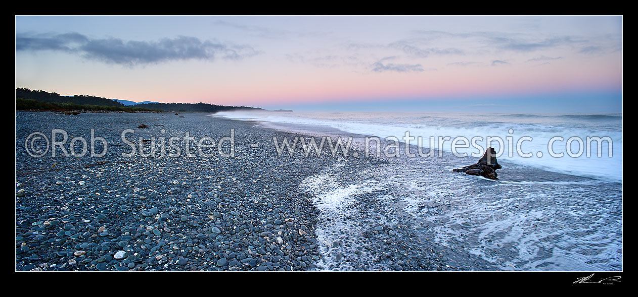 Image of Gillespies Beach on the wild South Westland coast. Panorama of waves, driftwood and shingle pebble beach early morning light before sun up, Gillespies Beach, Westland District, West Coast Region, New Zealand (NZ) stock photo image