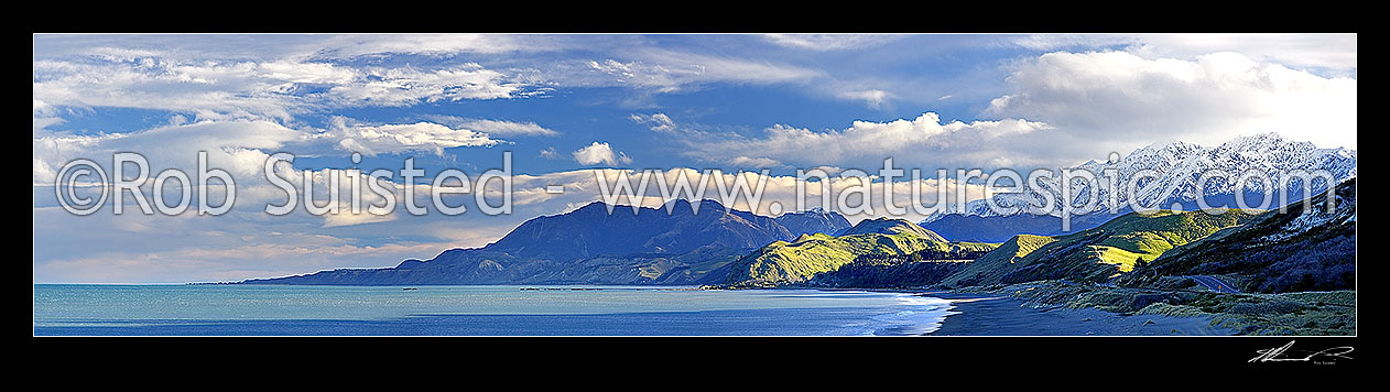 Image of Kaikoura Coastline. Later afternoon winter sun on the snowy Seaward Kaikoura Range and coastal farmland near Kekerengu and Clarence, Kaikoura, Kaikoura District, Canterbury Region, New Zealand (NZ) stock photo image