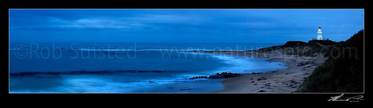 Image of Waipapa Point lighthouse and beach panorama on a moody evening, Fortrose, Southland District, Southland Region, New Zealand (NZ) stock photo image