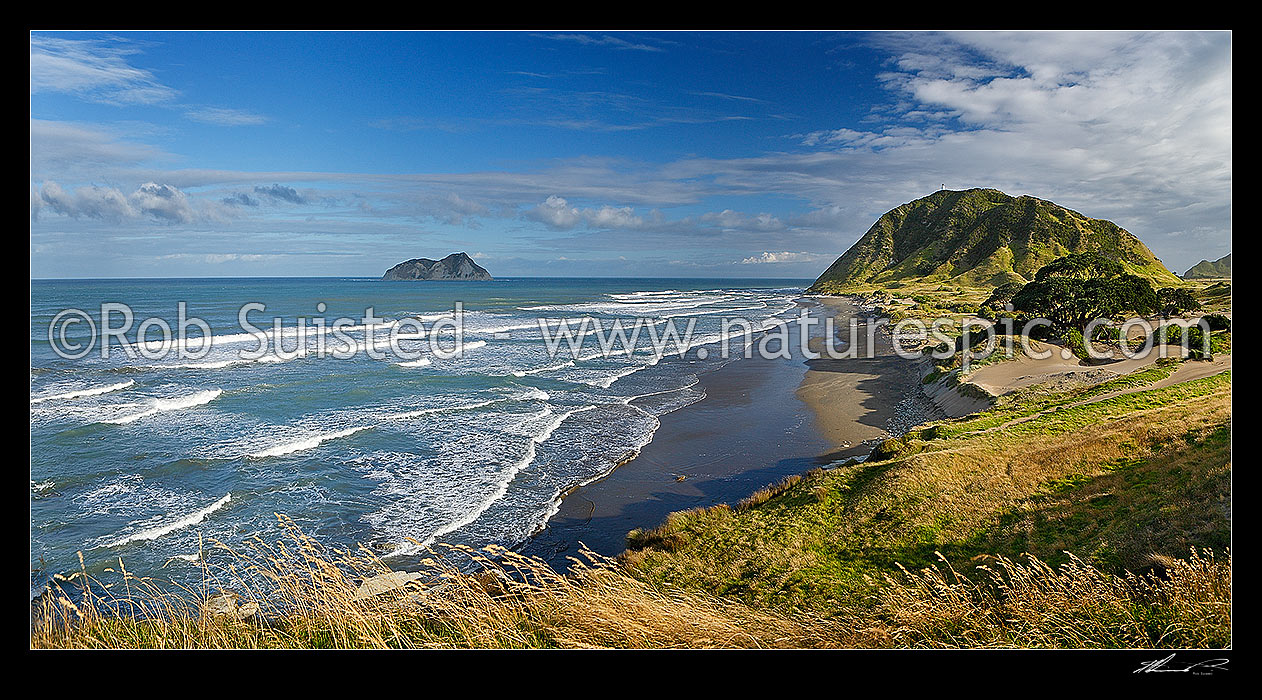 Image of East Cape marked by lighthouse on hill (141m). East Island (Whangoakeno) left. Panorama, East Cape, Gisborne District, Gisborne Region, New Zealand (NZ) stock photo image