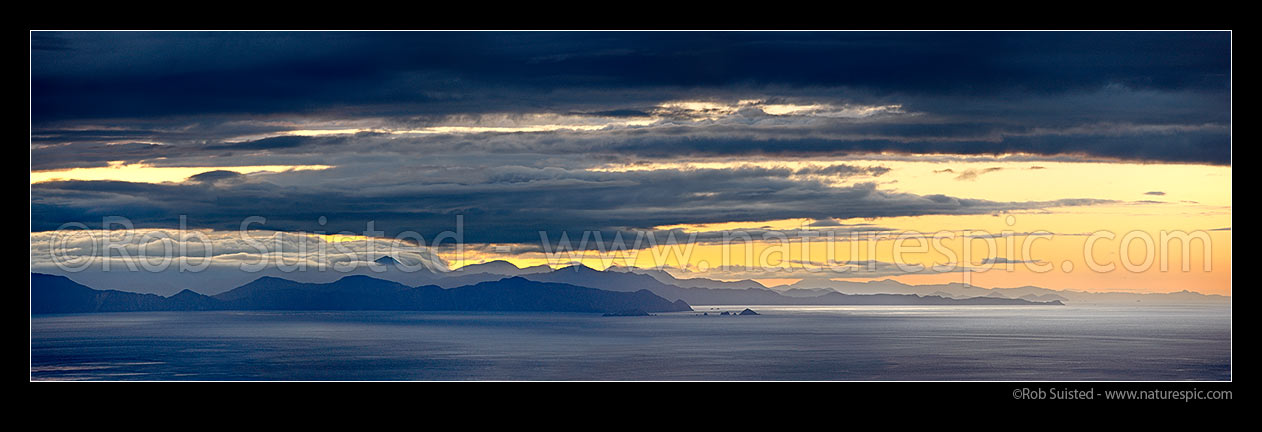 Image of Cook Strait evening panorama. Looking West towards Marlborough Sounds, Mount Stokes in cloud, The Brothers Islands (centre) and Cape Jackson (left), Cook Strait, Wellington City District, Wellington Region, New Zealand (NZ) stock photo image