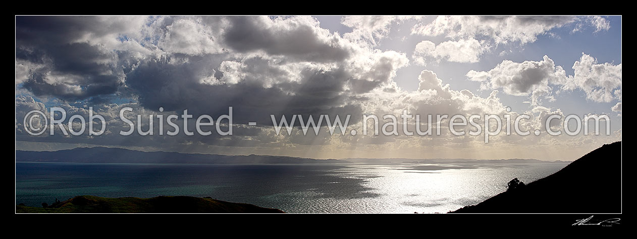 Image of Hauraki Gulf panorama. Moody sunshafts and clouds over sea near Kirita Bay, Coromandel Peninsula, looking towards Auckland, Coromandel, Thames-Coromandel District, Waikato Region, New Zealand (NZ) stock photo image