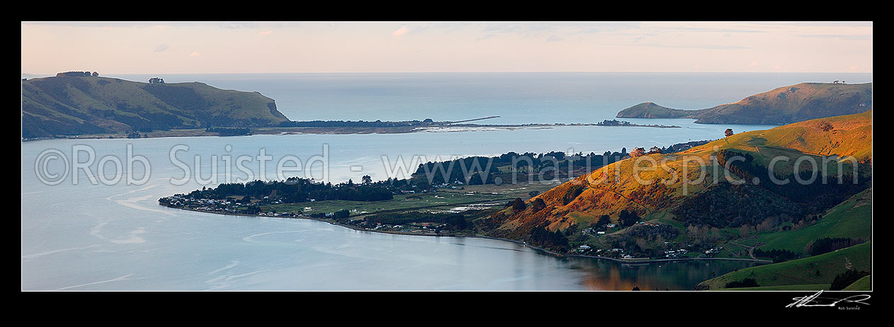 Image of Otago Harbour entrance at dusk looking past Harwood to Aramoana (left), The Spit, the Mole, and Taiaroa Head (right). Panorama, Otago Peninsula, Dunedin City District, Otago Region, New Zealand (NZ) stock photo image