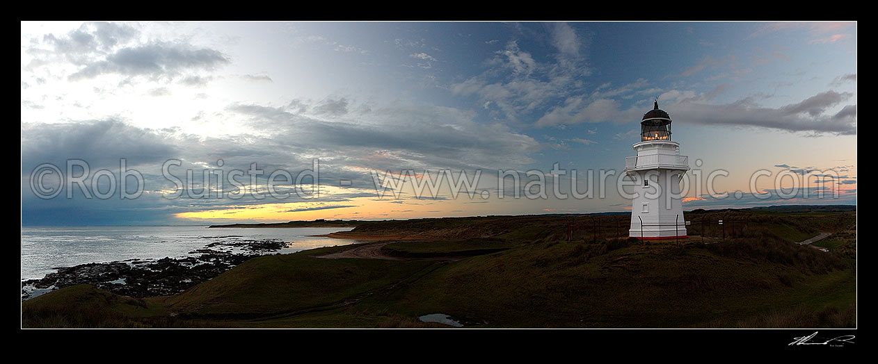 Image of Waipapa Point lighthouse and beach panorama on a moody evening sunset, Fortrose, Southland District, Southland Region, New Zealand (NZ) stock photo image