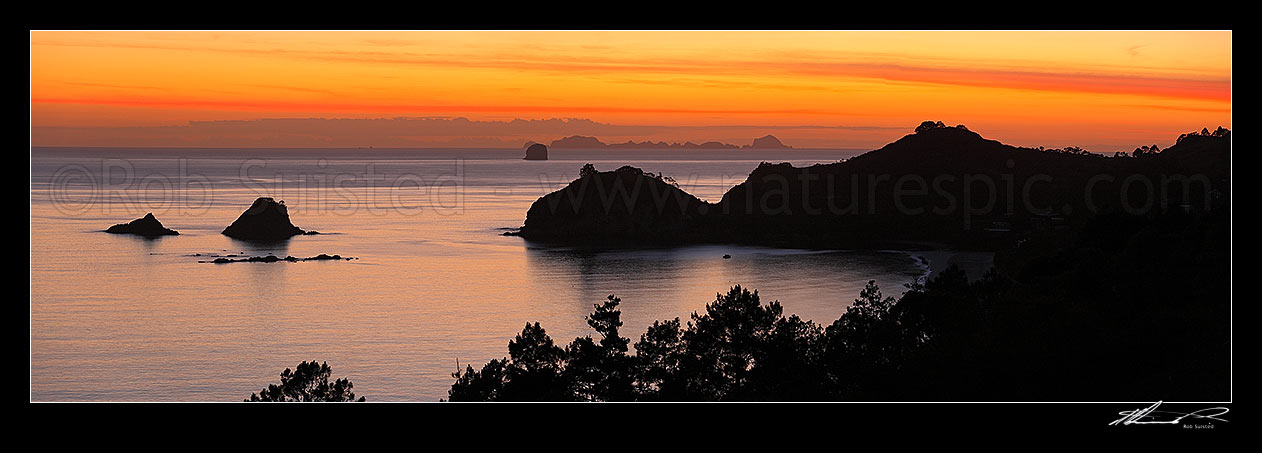 Image of Sunrise over Hahei Beach, Hereheretaura Point, Wigmore Pass and Te Karaka Island (left). The Aldermen Islands at right beyond. Peaceful morning panorama, Hahei, Coromandel Peninsula, Thames-Coromandel District, Waikato Region, New Zealand (NZ) stock photo image