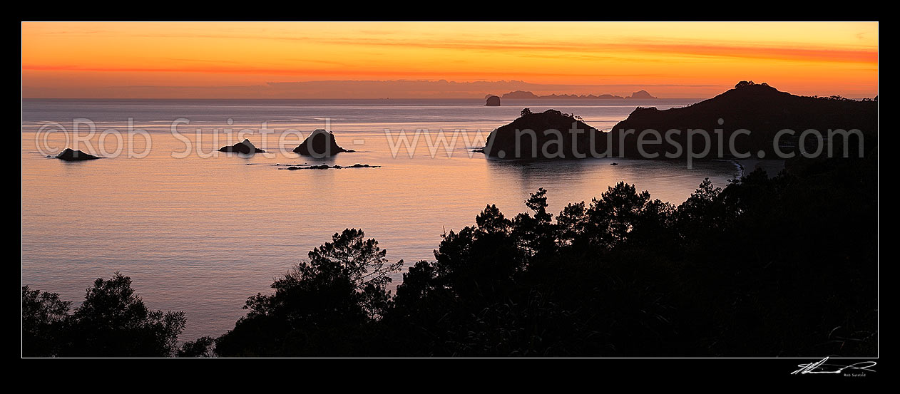 Image of Sunrise over Hahei Beach, Hereheretaura Point, Wigmore Pass and Te Karaka Island (left). The Aldermen Islands at right beyond. Peaceful morning panorama, Hahei, Coromandel Peninsula, Thames-Coromandel District, Waikato Region, New Zealand (NZ) stock photo image