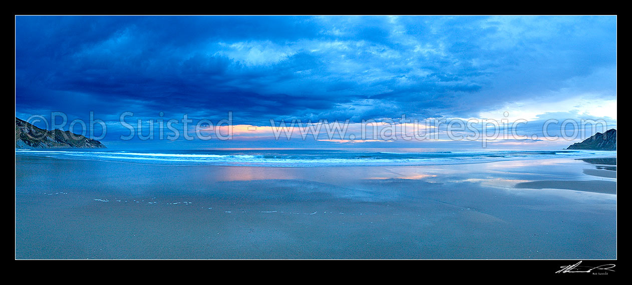 Image of Kaiaua Bay Beach moody sunset panorama, as storm clouds gather, with Marau Point left and Te Karaka Point right, Tolaga Bay, Gisborne District, Gisborne Region, New Zealand (NZ) stock photo image