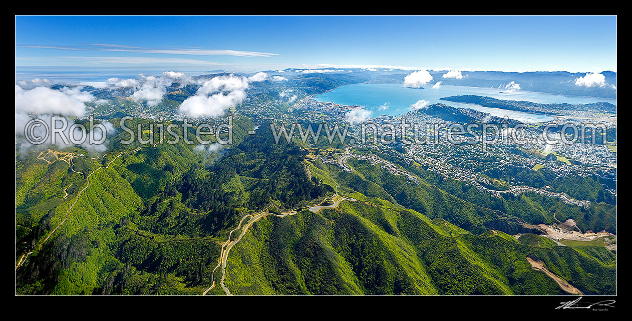 Image of Wellington City aerial view panorama. Karori Sanctuary Zealandia left, City and Harbour centre, Airport right. Wind turbine centre below. Earthquake faultline visible along left of harbour, Wellington City, Wellington City District, Wellington Region, New Zealand (NZ) stock photo image