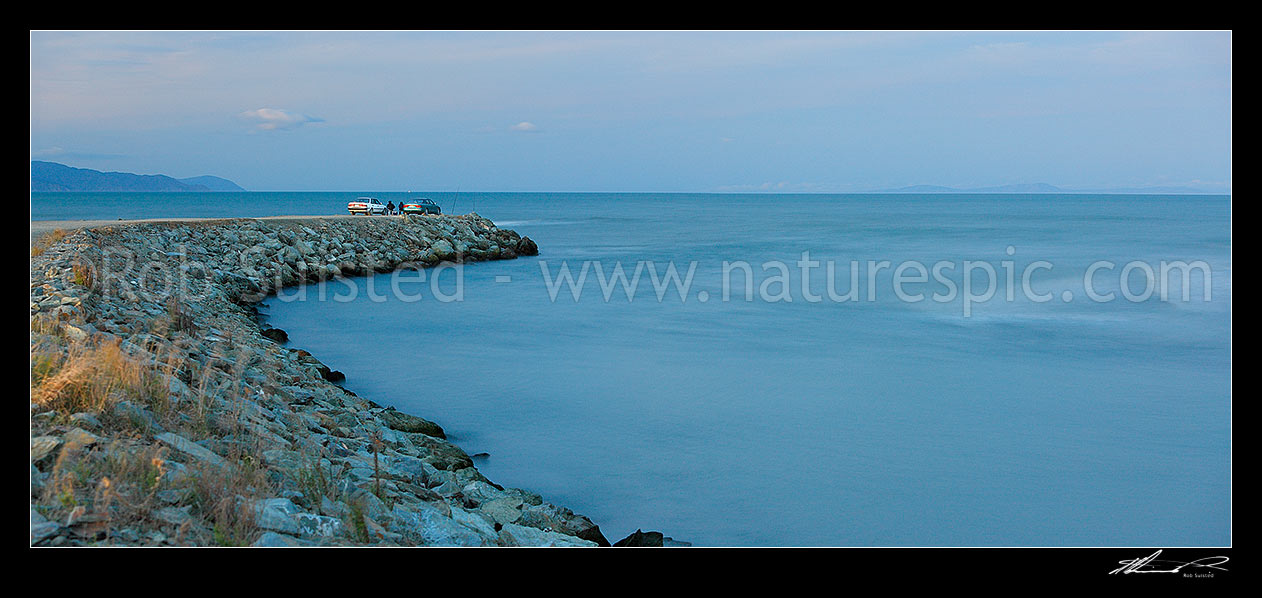 Image of Wairau River mouth and bar panorama. Cars and fishermen fishing at dusk. Cloudy Bay and North Island beyond, Blenheim, Marlborough District, Marlborough Region, New Zealand (NZ) stock photo image