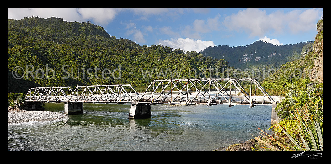 Image of Fox River Bridge, an historic timber truss bridge saved for walking access across Fox River. Paparoa National Park beyond. Panorama, Punakaiki, Buller District, West Coast Region, New Zealand (NZ) stock photo image