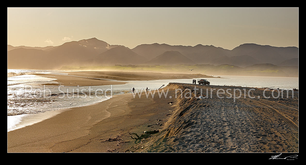 Image of Lake Onoke entrance and Ruamahanga River mouth in Palliser Bay with whitebaiters in evening. Remutaka (Rimutaka) Ranges and Mt Matthews beyond, Lake Ferry, South Wairarapa District, Wellington Region, New Zealand (NZ) stock photo image