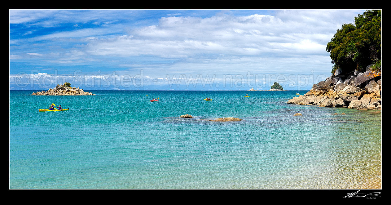 Image of Sea kayakers paddling on the Abel Tasman coastline. Panorama, Abel Tasman National Park, Tasman District, Tasman Region, New Zealand (NZ) stock photo image