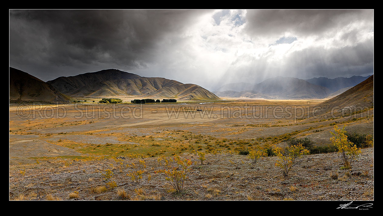 Image of Red Gate hut, airstrip and barn in the Severn River Valley (Alma River far left). Travellers Valley and Tarndale Brook centre, with Raglan Range behind in breaking weather. Panorama, Molesworth Station, Marlborough District, Marlborough Region, New Zealand (NZ) stock photo image