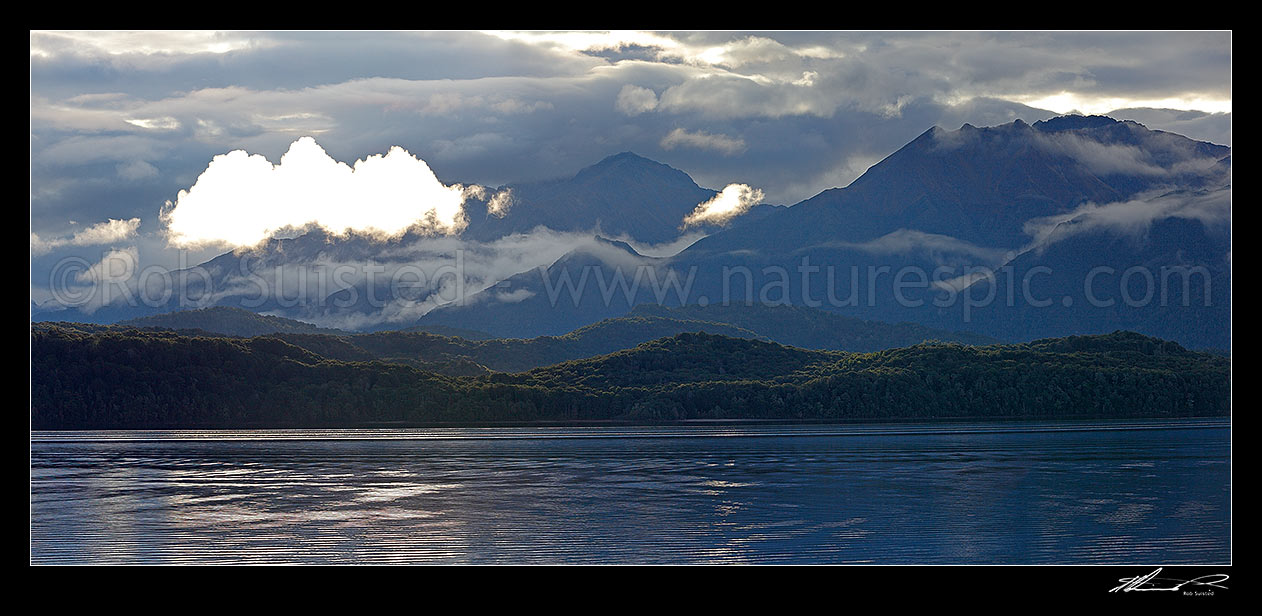 Image of Lake Te Anau and Fiordland, with the Murchison Mountains beyond as mist lifts in the evening. Mt Owen centre. Panorama, Fiordland National Park, Southland District, Southland Region, New Zealand (NZ) stock photo image