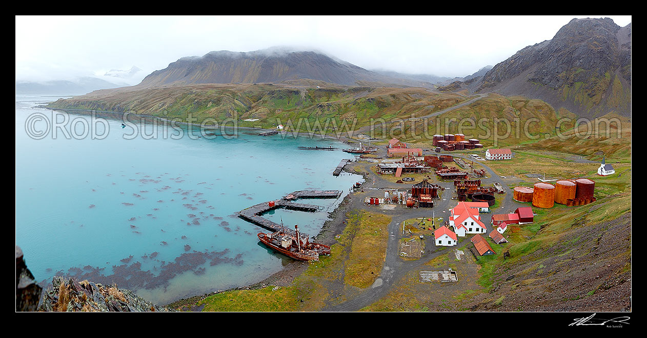 Image of Grytviken whaling station remains in King Edward Cove. Whaling boats 'Dias' and 'Albatross' and museum foreground, and whalers church at left. Panorama, King Edward Cove, South Georgia stock photo image