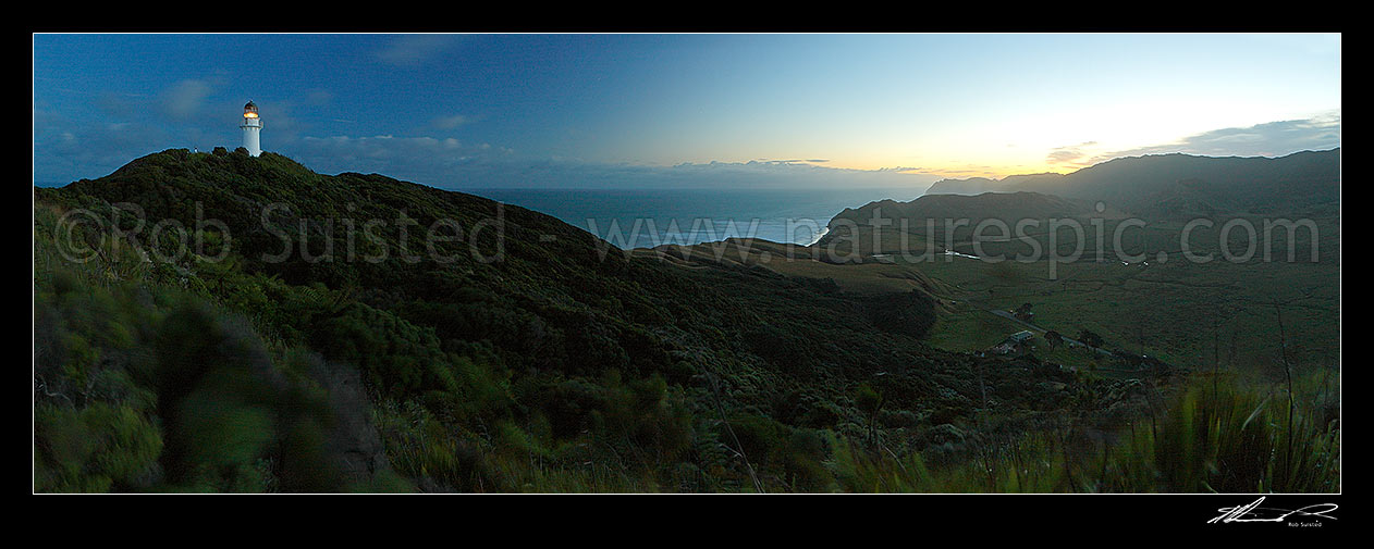 Image of East Cape lighthouse at dusk, Tunanui Stream and Waikori Bluff distant right. Panorama, East Cape, Gisborne District, Gisborne Region, New Zealand (NZ) stock photo image