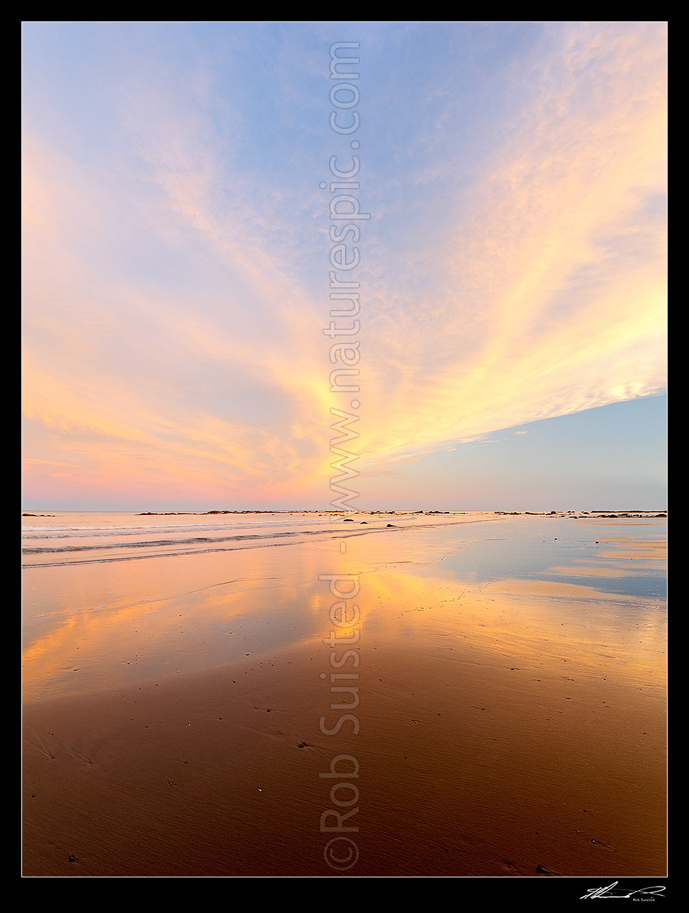 Image of Golden wispy sunest clouds reaching across sky and reflecting in beach sands of Port Awanui. Square format, Port Awanui, East Coast, Gisborne District, Gisborne Region, New Zealand (NZ) stock photo image