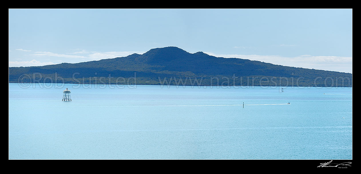 Image of Rangitoto Island volcanic cone and the Motukorea Channel with pleasure boat passing Bean Rock lighthouse guarding Bean Rocks. Panorama, Rangitoto Island, Auckland City District, Auckland Region, New Zealand (NZ) stock photo image