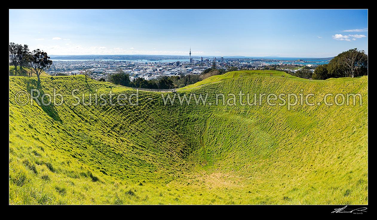 Image of Mount Eden (Maungawhau) volcanic cone crater and summit above sweeping panorama of Auckland Cityand Waitemata Harbour. Mt Eden, Auckland City, Auckland City District, Auckland Region, New Zealand (NZ) stock photo image