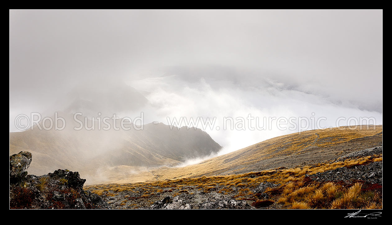 Image of Kepler Track Great walk track view from Mount Luxmore on a moody misty morning with low cloud over Lake Te Anau. Panorama, Fiordland National Park, Southland District, Southland Region, New Zealand (NZ) stock photo image