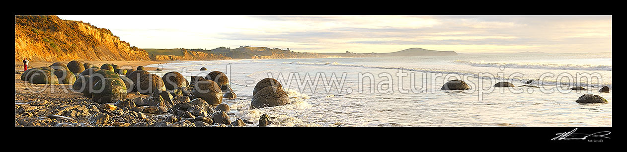 Image of Moeraki Boulders / Kaihinaki on Koekohe Beach. 60 Million year old mudstone concretions and famous tourist spot. Very wide large panorama file, Moeraki, Waitaki District, Canterbury Region, New Zealand (NZ) stock photo image