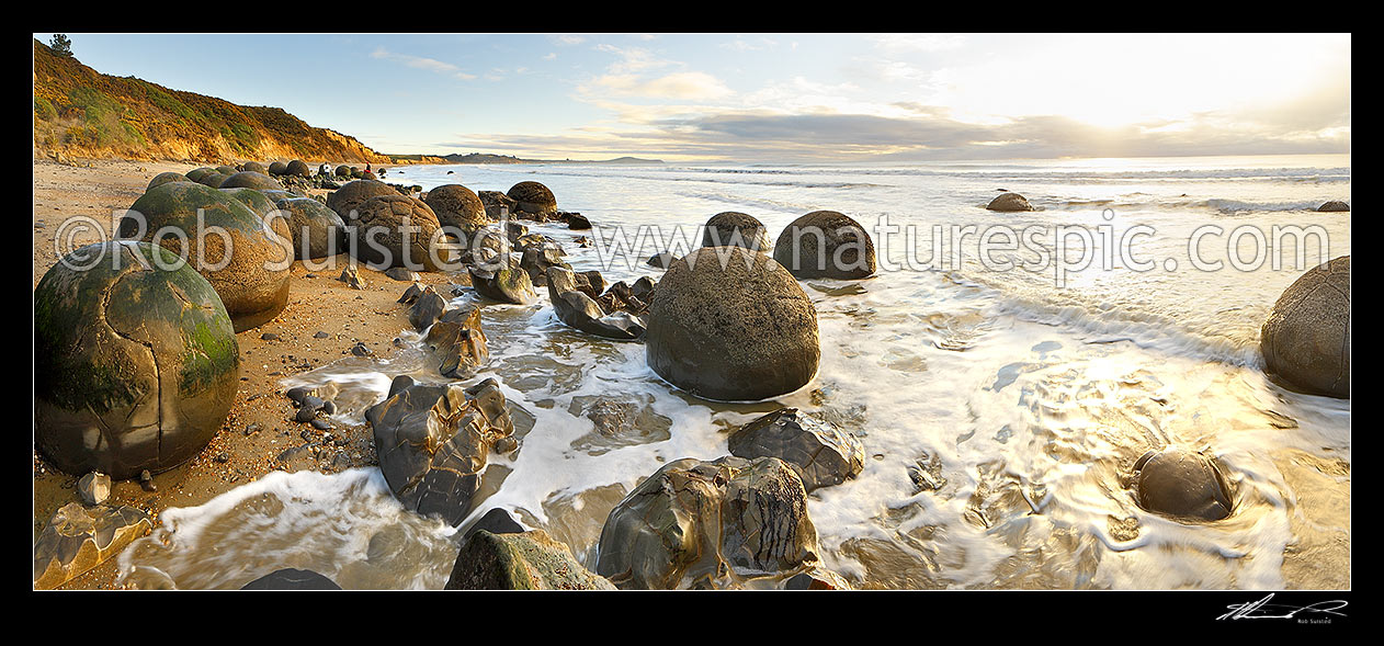 Image of Moeraki Boulders / Kaihinaki on Koekohe Beach at sunrise. 60 Million year old mudstone concretions. Panorama, Moeraki, Waitaki District, Canterbury Region, New Zealand (NZ) stock photo image