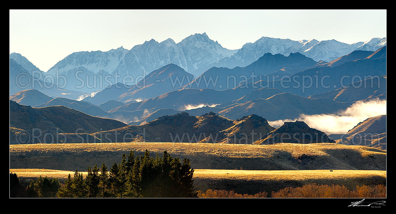 Image of Mount Tapuae-o-Uenuku (2885m) and Inland Kaikoura Ranges panorama on a calm golden Autumn morning as mist lifts from valleys, Molesworth Station, Marlborough District, Marlborough Region, New Zealand (NZ) stock photo image