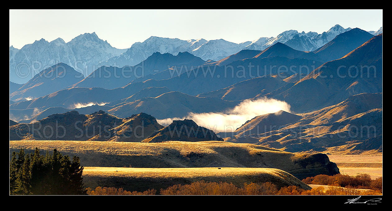 Image of Mount Tapuae-o-Uenuku (2885m) and Inland Kaikoura Ranges panorama on a calm golden Autumn morning as mist lifts from valleys, Molesworth Station, Marlborough District, Marlborough Region, New Zealand (NZ) stock photo image