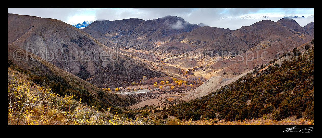 Image of Elliott Stream valley in autumn colours, with Elliott Hut / Bivvy centre right. Lizard Stream centre top, and Seaward Kaikoura Range in distant left. Looking down faultline. Panorama, Molesworth Station, Marlborough District, Marlborough Region, New Zealand (NZ) stock photo image