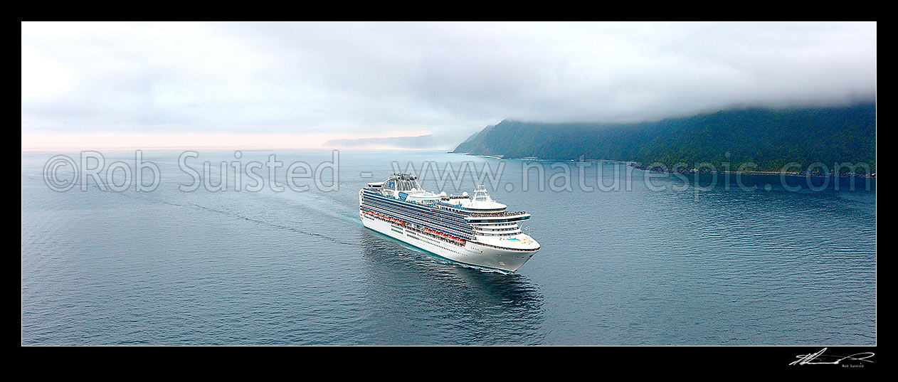 Image of Cruise ship arriving off the Milford Sound fiord entrance on a moody early morning. Princess Cruises Diamond Princess vessel with Yates Point behind. Large aerial panorama, Milford Sound, Fiordland National Park, Southland District, Southland Region, New Zealand (NZ) stock photo image