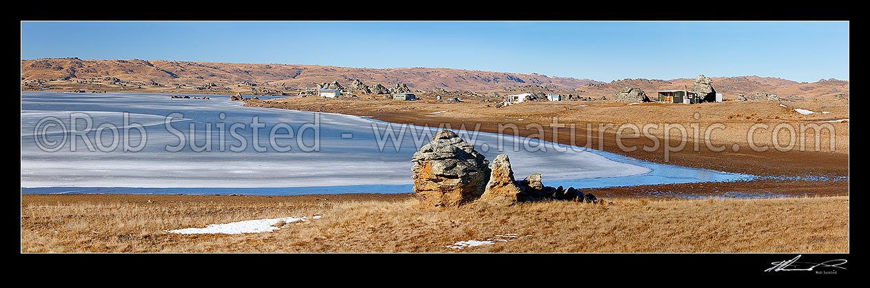 Image of Poolburn reservior frozen in winter with fishing baches and cribs around edge, used as the Lord of the Rings location Rohan. Panorama, Ida Burn Valley, Central Otago District, Otago Region, New Zealand (NZ) stock photo image