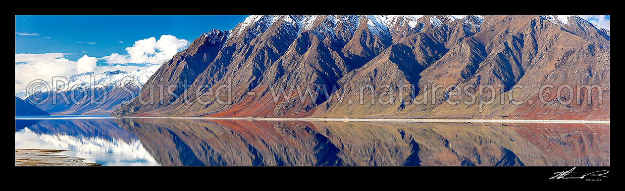 Image of Lake Hawea reflecting the snow covered Huxley Range and Hunter River Valley far left and rugged mountains. Panorama, Lake Hawea, Otago, Queenstown Lakes District, Otago Region, New Zealand (NZ) stock photo image