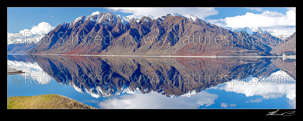 Image of Lake Hawea on a perfect calm spring/winter day reflecting the surrounding snowy ranges, Huxley Range, Dingle Burn far right, Timaru River far right. Panorama, Lake Hawea, Otago, Queenstown Lakes District, Otago Region, New Zealand (NZ) stock photo image