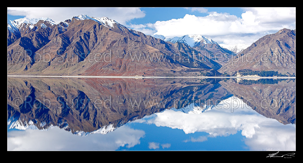 Image of Lake Hawea on a perfect calm spring/winter day reflecting the surrounding snowy ranges, Timaru River far right. Panorama, Lake Hawea, Otago, Queenstown Lakes District, Otago Region, New Zealand (NZ) stock photo image