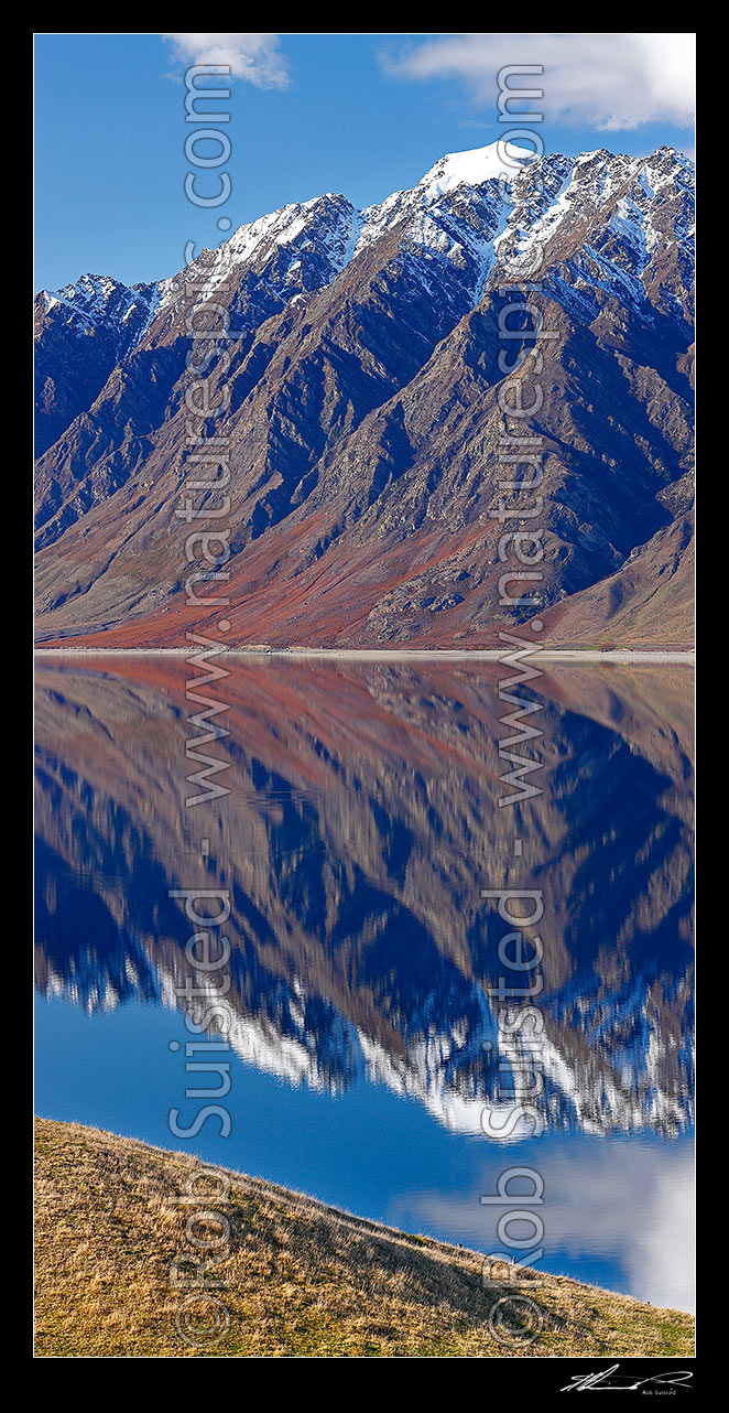 Image of Lake Hawea on a perfect calm spring/winter day reflecting the surrounding snowy ranges. Vertical panorama, Lake Hawea, Otago, Queenstown Lakes District, Otago Region, New Zealand (NZ) stock photo image