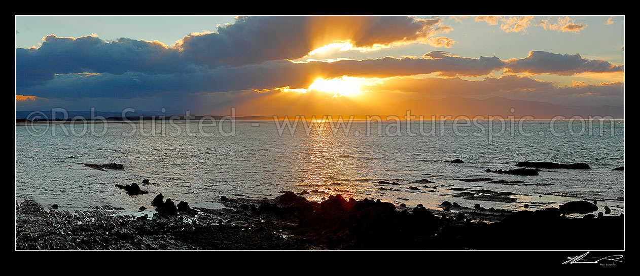 Image of Dramatic sunset over Tasman Bay, Rabbit Island and Tahunanui Beach. Panorama, Nelson, Nelson City District, Nelson Region, New Zealand (NZ) stock photo image