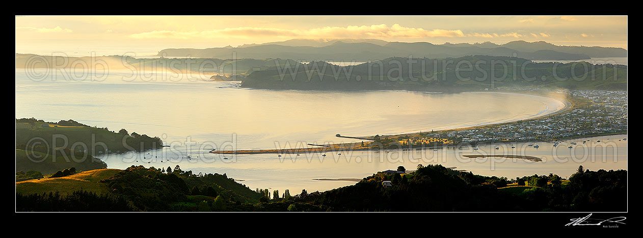 Image of Omaha Beach and Bay. Whangateau Harbour entrance, Ti Point and Tawharanui Peninsula at left with Kawau Island beyond, at dawn. Panorama, Leigh, Rodney District, Auckland Region, New Zealand (NZ) stock photo image