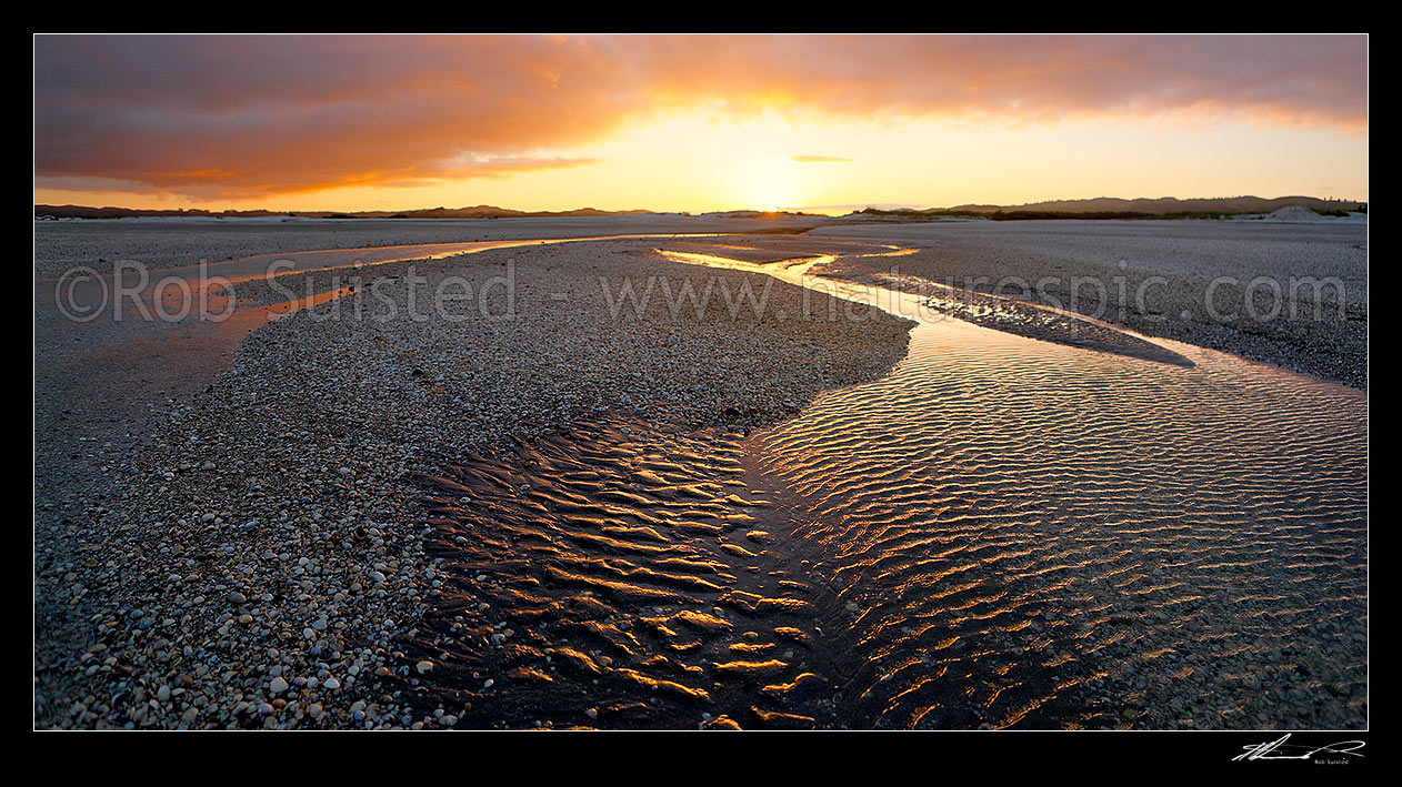 Image of Sunset over shellbanks and stream on the Hauraki Gulf coast near Miranda. Panorama, Kaiaua, Franklin District, Waikato Region, New Zealand (NZ) stock photo image