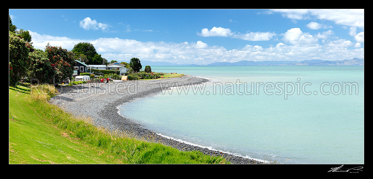 Image of Hauraki Gulf houses and holiday homes nestled on the Waharau shore near Wharekawa. Coromandel Ranges distant. Panorama, Kaiaua, Franklin District, Waikato Region, New Zealand (NZ) stock photo image