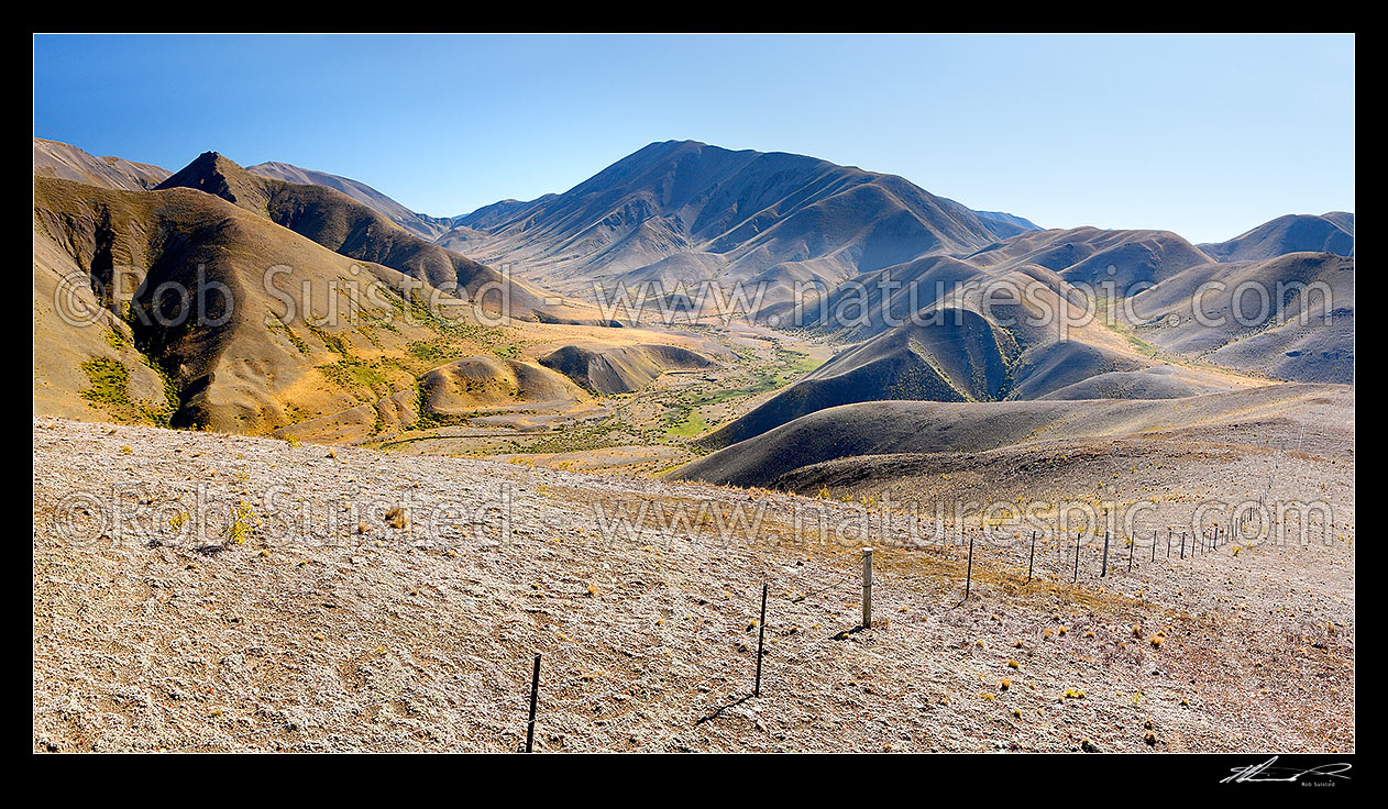 Image of Guide River and Barefell Pass (left), with Half Moon Stream far right. Summer panorama with high country stock fence, Molesworth Station, Marlborough District, Marlborough Region, New Zealand (NZ) stock photo image