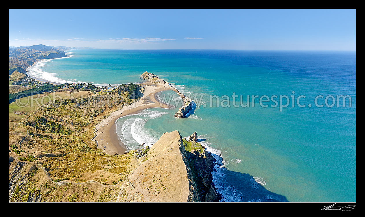 Image of Castlepoint lighthouse, reef, lagoon and village, from above Castle Rock (162m). Aerial panorama looking north to Cape Turnagain, Castlepoint, Masterton District, Wellington Region, New Zealand (NZ) stock photo image