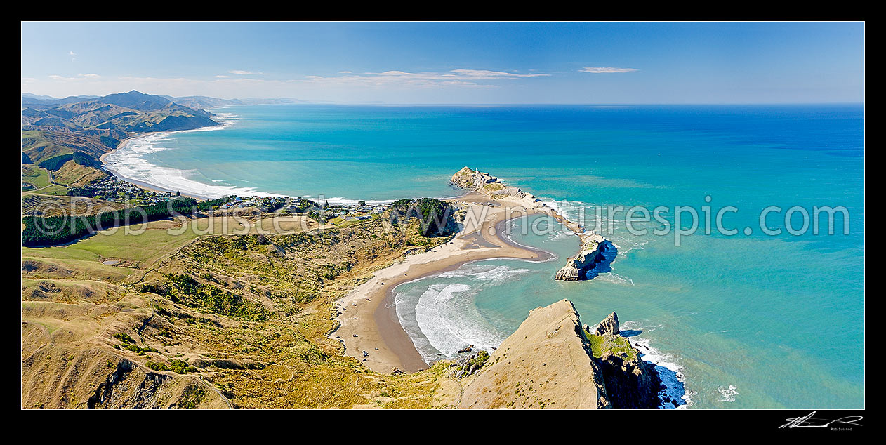 Image of Castlepoint lighthouse, reef, lagoon and village, from above Castle Rock (162m). Castlepoint Scenic Reserve. Aerial panorama, Castlepoint, Masterton District, Wellington Region, New Zealand (NZ) stock photo image