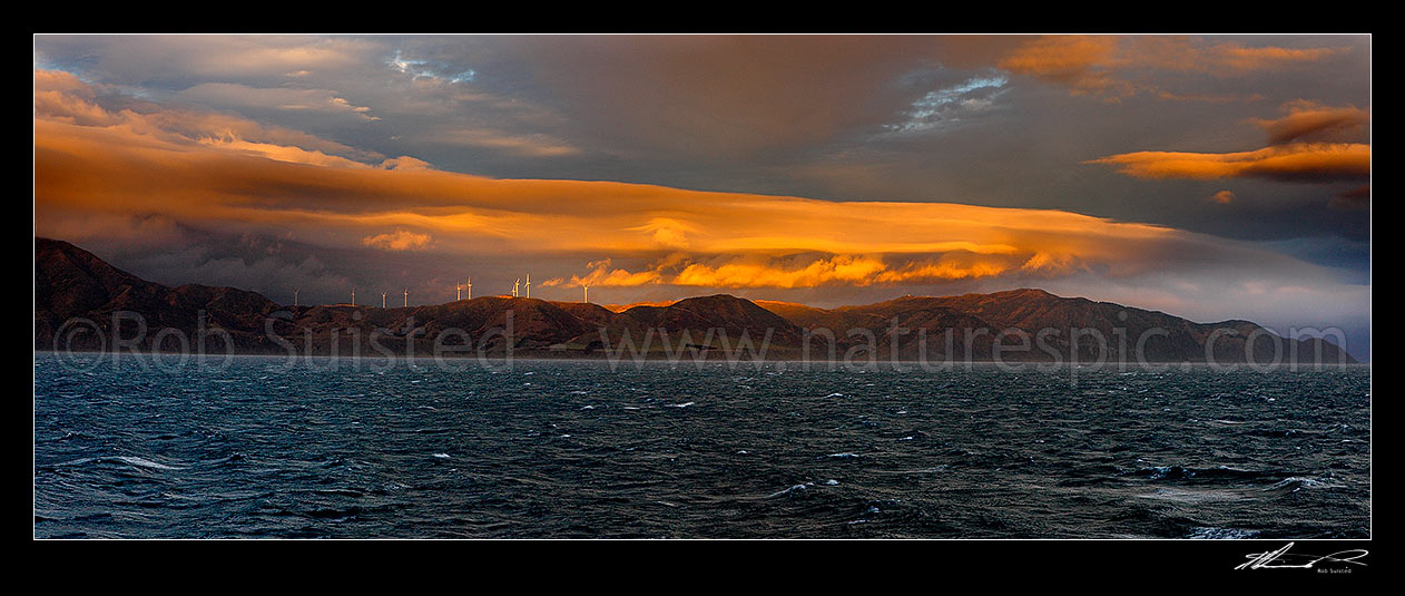 Image of Breaking weather over the Meridian Energys Project West Wind farm turbines on Wellington's South Coast, seen from Cook Strait. Terawhiti coast and station. Panorama, Cape Terawhiti, Wellington City District, Wellington Region, New Zealand (NZ) stock photo image