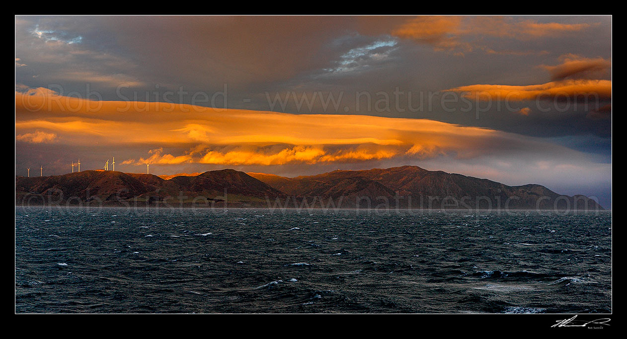 Image of Breaking weather over the Meridian Energys Project West Wind farm turbines on Wellington's South Coast, seen from Cook Strait. Terawhiti coast and station. Panorama, Cape Terawhiti, Wellington City District, Wellington Region, New Zealand (NZ) stock photo image