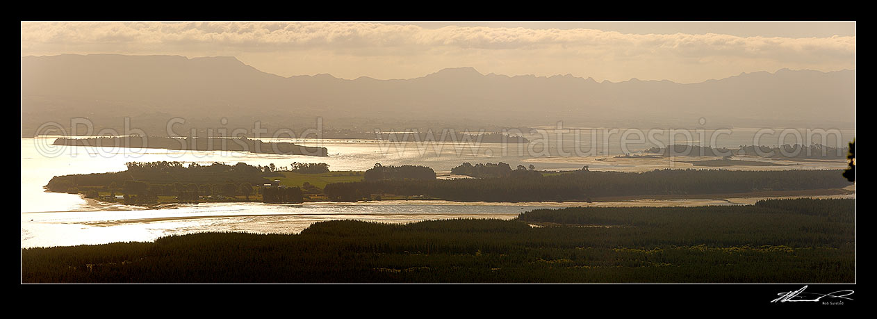 Image of Tauranga Harbour panorama with Matakana Island foreground, Rangiwaea Is. Centre, Motuhoa Is. left, and Kaimai Ranges behind, Mount Maunganui, Tauranga District, Bay of Plenty Region, New Zealand (NZ) stock photo image