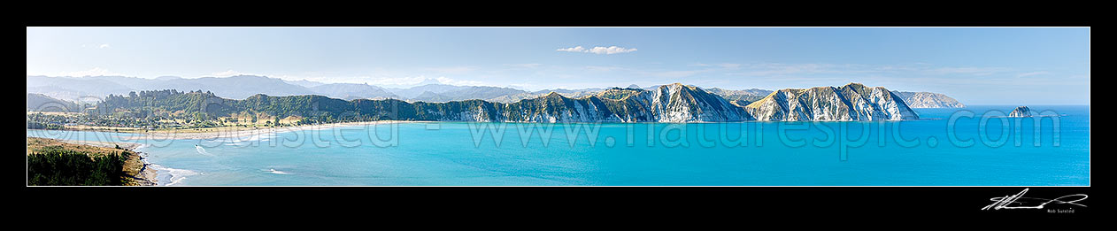 Image of Tolaga Bay from the Uawa River mouth across to Te Karaka Point (and island) and Marau Point. Mt Hikurangi (1752m) distant centre left. Panorama, Tolaga Bay, Gisborne District, Gisborne Region, New Zealand (NZ) stock photo image