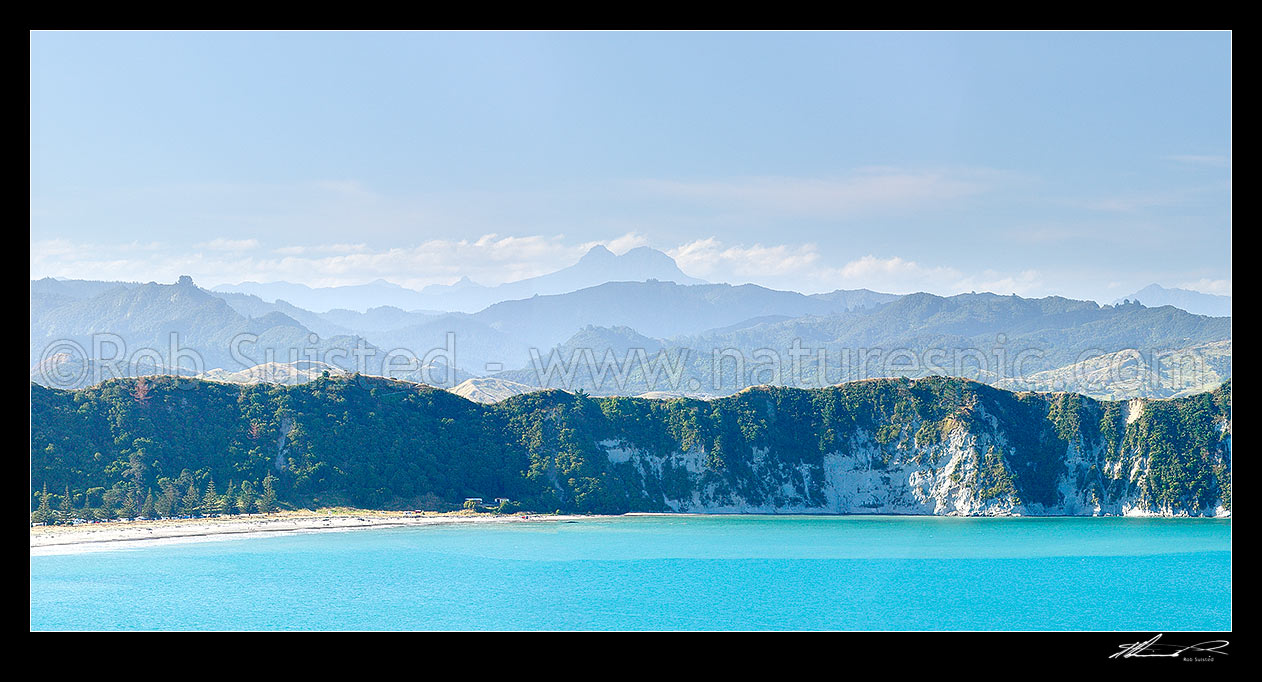 Image of Tolaga Bay with Mount Hikurangi (1752m) and Raukumara Ranges towering distantly beyond. Panorama, Tolaga Bay, Gisborne District, Gisborne Region, New Zealand (NZ) stock photo image