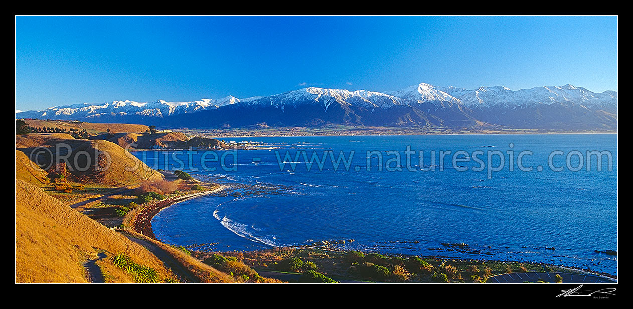 Image of Kaikoura township, snowy Seaward Kaikoura Range and Mt Fyffe beyond, from the Peninsula and Point Kean. Panorama, Kaikoura, Kaikoura District, Canterbury Region, New Zealand (NZ) stock photo image